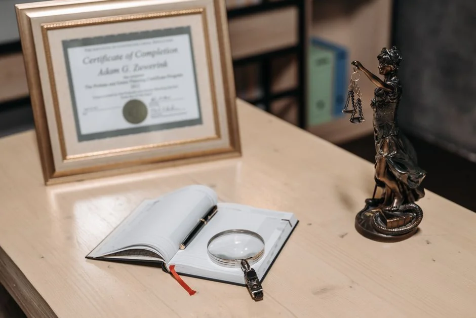 A framed certificate with Lady Justice statue on a wooden desk. - 人工智能领域专利布局指引a complete guide
