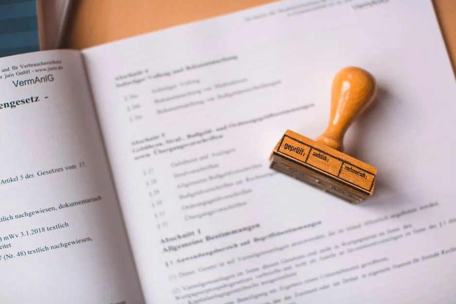 Close-up of a legal document with a wooden stamp placed on top, highlighting verification. - 人工智能领域专利布局指引a complete guide