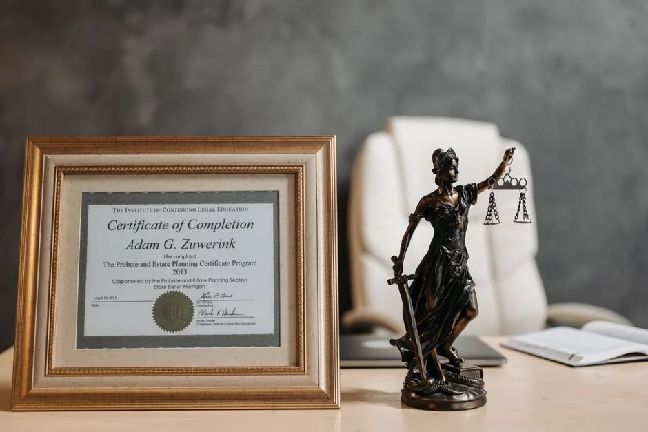 A framed legal certificate and Lady Justice figurine on a desk in a law office setting. - 人工智能领域专利布局指引a complete guide