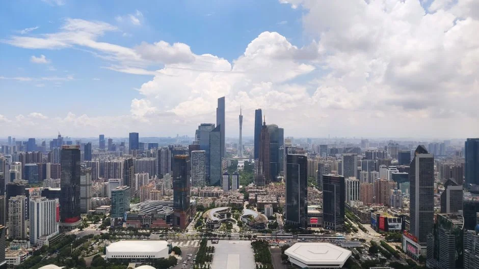 A stunning aerial view of Guangzhou's cityscape and skyscrapers under a blue sky. - 广州包装材料机械设备研发企业怎么构建专利壁垒防止竞品抄袭packaging machinery